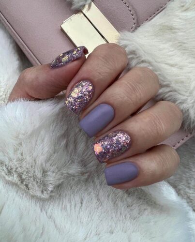 A view of lavender and gold shimmer nails A view of lavender and gold shimmer nails