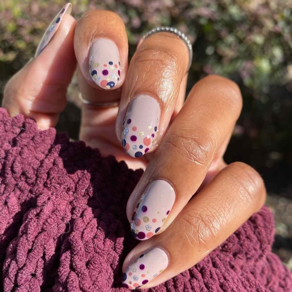 A view of lavender nails with pink polka dots A view of lavender nails with pink polka dots