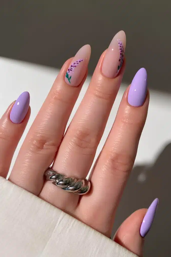 A view of purple nails with floral design A view of purple nails with floral design