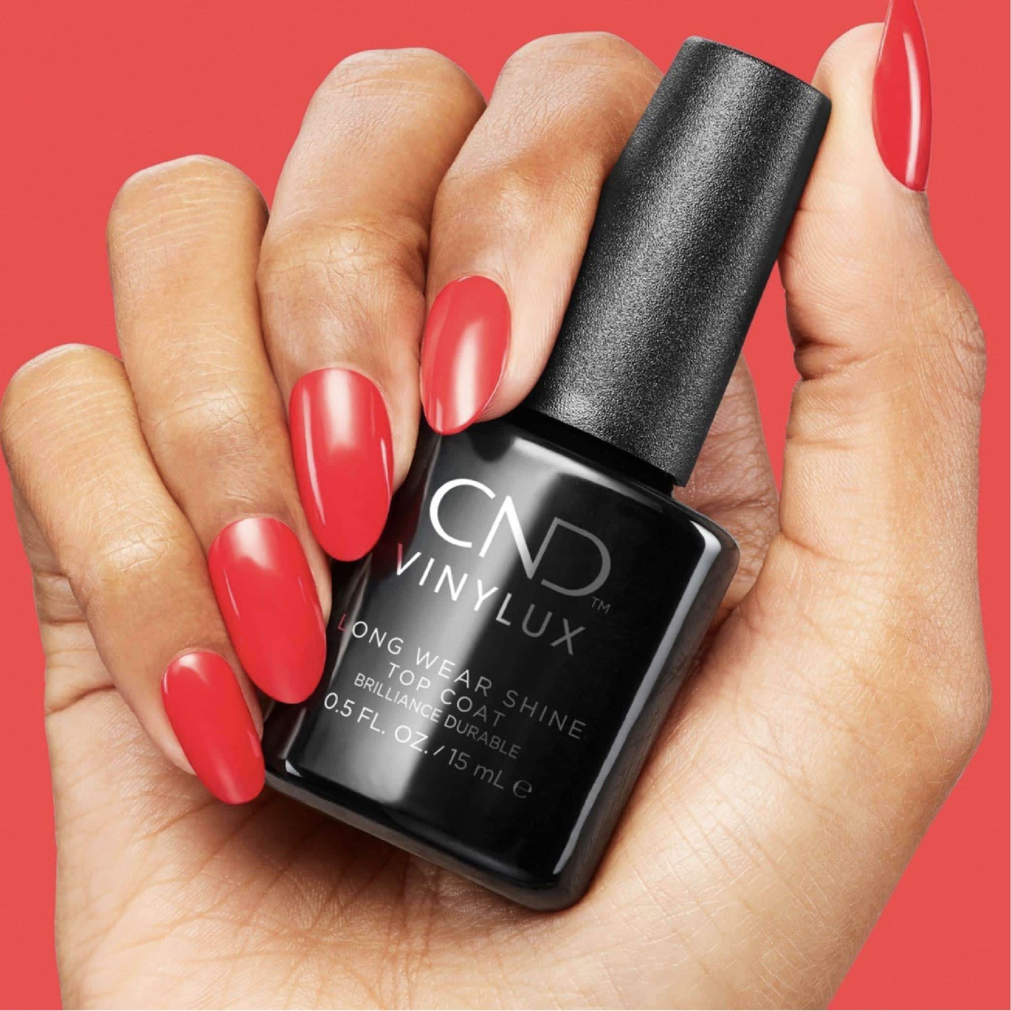 hand with nail polish holding a bottle hand with nail polish holding a bottle