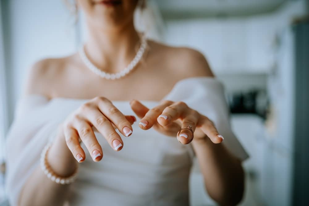 A view of a bride with french manicure tips A view of a bride with french manicure tips