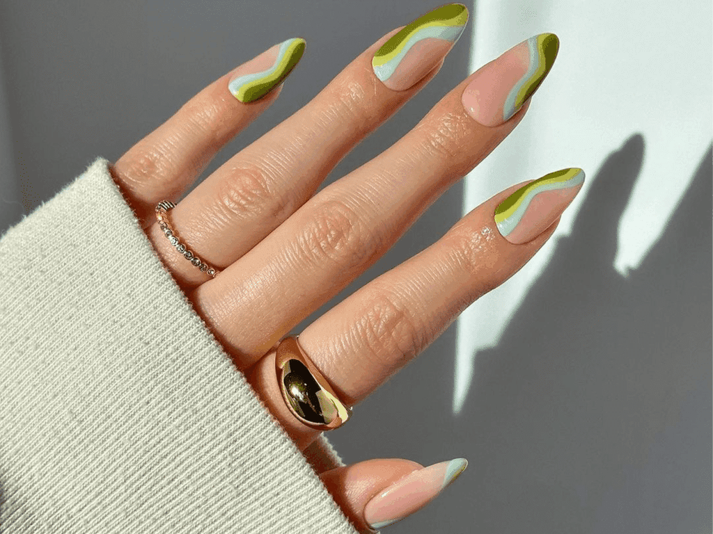 A view of a green nail manicure with rings A view of a green nail manicure with rings