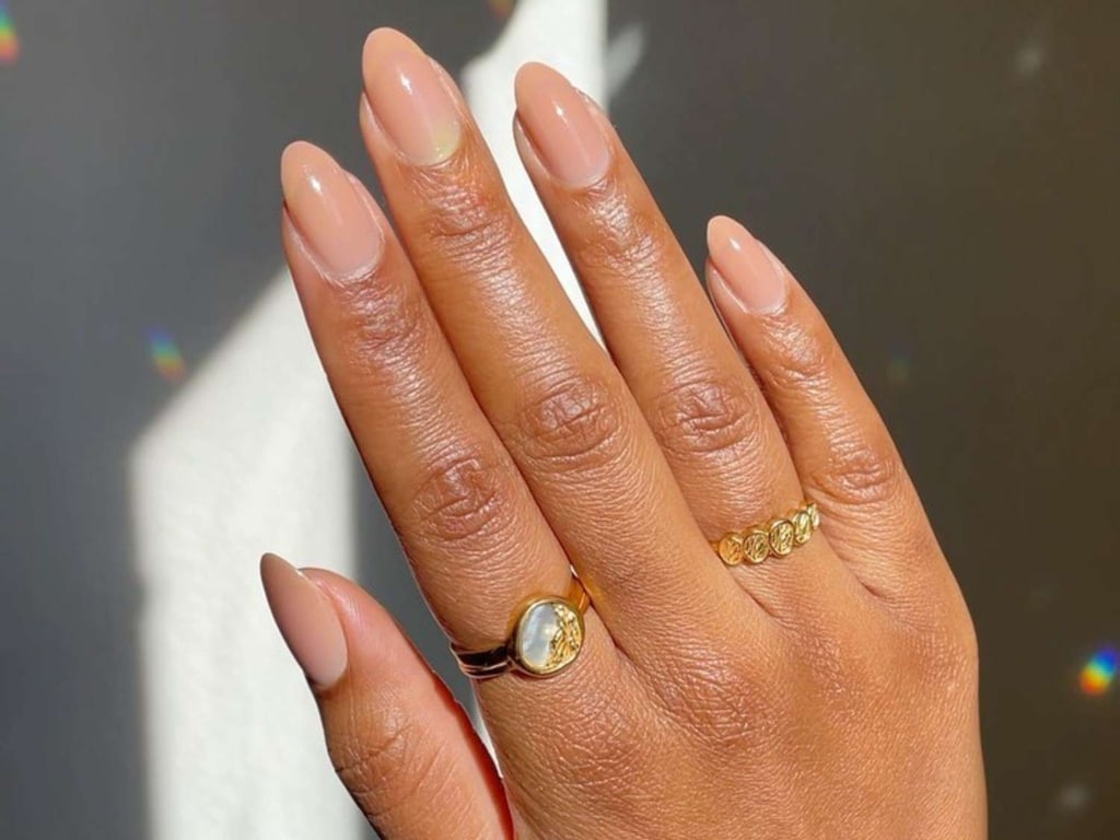 A view of hands showing nude nails A view of hands showing nude nails