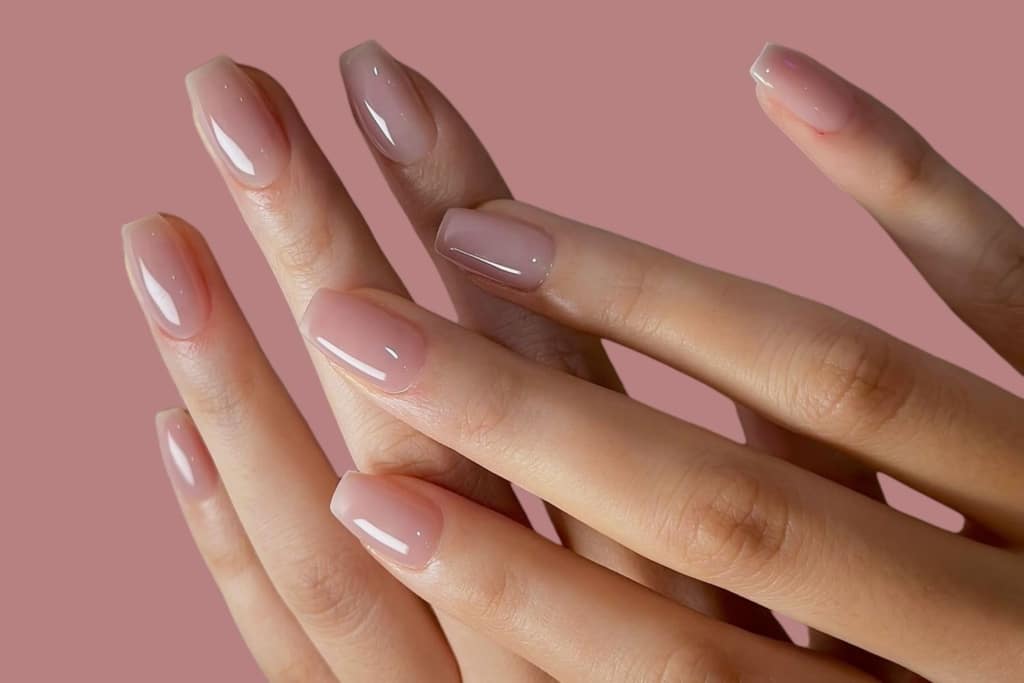 A view of hands showing off nude color nails A view of hands showing off nude color nails