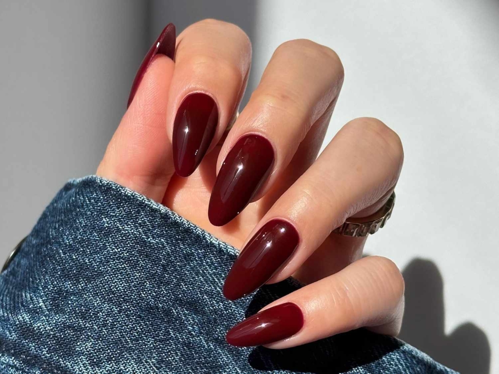 A view of hands showing off burgundy fall nails A view of hands showing off burgundy fall nails