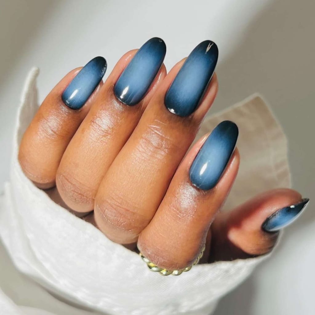 A view of hands with blue aura nails A view of hands with blue aura nails