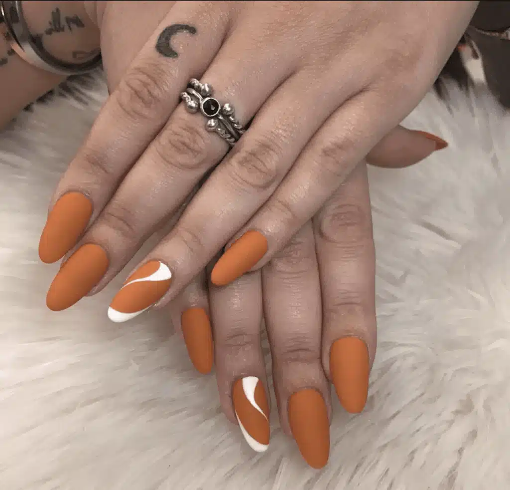 A view of orange and white nails A view of orange and white nails